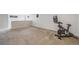 Finished basement with plush carpet, an exercise bike, and abundant space for recreational activities or storage at 13367 W Montana Pl, Lakewood, CO 80228