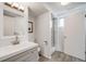 Modern bathroom with gray vanity, white sink, and walk-in shower for a luxurious experience at 13367 W Montana Pl, Lakewood, CO 80228