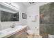 Modern bathroom featuring a gray vanity, glass enclosed shower, and neutral tile for a relaxing experience at 13367 W Montana Pl, Lakewood, CO 80228