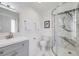 Modern bathroom featuring a glass-enclosed shower, gray vanity, and elegant fixtures for a spa-like experience at 13367 W Montana Pl, Lakewood, CO 80228