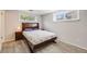 Cozy bedroom featuring warm wood furnishings and natural light from the double window at 13367 W Montana Pl, Lakewood, CO 80228