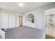 Bedroom featuring gray walls, carpet, and a bed with a gray comforter, providing a comfortable retreat at 13367 W Montana Pl, Lakewood, CO 80228