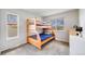 Bright bedroom featuring a wooden bunk bed, carpeted floor, and natural light, creating a cozy ' space at 13367 W Montana Pl, Lakewood, CO 80228