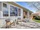 Inviting front porch seating area with charming chairs, enhancing the curb appeal of this brick ranch-style home at 13367 W Montana Pl, Lakewood, CO 80228