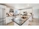 Modern kitchen featuring white cabinetry, stainless steel appliances, an island, and stylish countertops at 13367 W Montana Pl, Lakewood, CO 80228