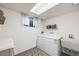 Functional laundry room with washer, dryer, and utility sink providing convenience at 13367 W Montana Pl, Lakewood, CO 80228