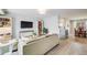Open-concept living space with a comfortable couch, sleek television, and seamless flow to the dining area at 13367 W Montana Pl, Lakewood, CO 80228