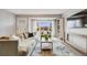 Bright living room with a large window, comfortable seating, modern decor, and light wood flooring at 13367 W Montana Pl, Lakewood, CO 80228