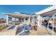 The backyard features a covered patio, an outdoor dining space, and a white pergola at 885 Delechant Dr, Erie, CO 80516