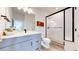 Bathroom with a light vanity, large mirror, and a glass enclosed shower at 885 Delechant Dr, Erie, CO 80516
