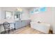 Contemporary bathroom showcasing a soaking tub, dual vanity, and stylish fixtures at 885 Delechant Dr, Erie, CO 80516