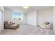 Inviting bedroom with cozy chairs and ottoman, plenty of space, and bright window at 885 Delechant Dr, Erie, CO 80516
