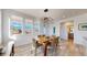 Bright dining area featuring large windows, modern light fixture, and comfortable seating at 885 Delechant Dr, Erie, CO 80516