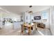 Well-lit dining room showcasing modern light fixture, wood floors, and access to the kitchen at 885 Delechant Dr, Erie, CO 80516