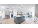 Spacious kitchen showcasing a center island, modern cabinets, and an open layout design at 885 Delechant Dr, Erie, CO 80516