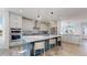 Modern kitchen featuring a large island with seating, sleek appliances, and plenty of cabinet space at 885 Delechant Dr, Erie, CO 80516