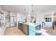 Stylish kitchen featuring an island with seating, stainless steel appliances, and wood flooring at 885 Delechant Dr, Erie, CO 80516