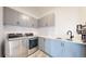 This laundry room features stainless steel washer and dryer, modern cabinetry, and a sink at 885 Delechant Dr, Erie, CO 80516
