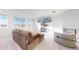 Bright living room featuring a plush sofa, modern decor, large windows and plenty of natural light at 885 Delechant Dr, Erie, CO 80516