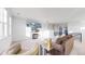 Open-concept living room boasts a large, comfortable sofa, stylish furnishings, and views of the outside at 885 Delechant Dr, Erie, CO 80516
