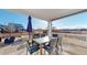 Enjoy this outdoor patio with a dining table, grill, fire pit, and lush views at 885 Delechant Dr, Erie, CO 80516