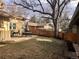 Fenced backyard with patio, dining set, grill, and mature trees at 2045 S Monroe St, Denver, CO 80210