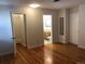 This bedroom shows wood flooring that leads to a door and bathroom at 2045 S Monroe St, Denver, CO 80210