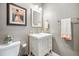 Neutral-toned bathroom with modern sink, vanity, and framed artwork at 3039 N Milwaukee St, Denver, CO 80205