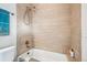 Neutral bathroom featuring a shower-tub combo and light wood tile at 3039 N Milwaukee St, Denver, CO 80205