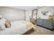 Basement bedroom with gray dresser and adjacent office space at 3039 N Milwaukee St, Denver, CO 80205