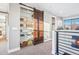 Hallway with storage space featuring a sliding barn door, built-in shelves, and natural light from nearby window at 3039 N Milwaukee St, Denver, CO 80205