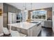 Modern kitchen with a large island, stainless steel appliances, and wood accent wall at 3039 N Milwaukee St, Denver, CO 80205