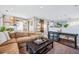 Comfortable living room featuring a brown sectional sofa, entertainment center, and neutral-toned carpet at 3039 N Milwaukee St, Denver, CO 80205