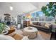 Spacious living room with hardwood floors, a gray sofa, leather chairs, and lots of natural light at 3039 N Milwaukee St, Denver, CO 80205