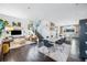 Open-concept living area with modern furniture, a stylish staircase, and hardwood floors at 3039 N Milwaukee St, Denver, CO 80205