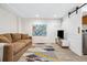 Basement entertainment area with a brown sofa, colorful rug and mounted TV at 3039 N Milwaukee St, Denver, CO 80205