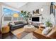 Bright living room with large windows, a gray sofa, leather chairs, and hardwood floors at 3039 N Milwaukee St, Denver, CO 80205