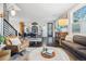 Open-concept living room with a dining area, hardwood floors, and stylish furniture at 3039 N Milwaukee St, Denver, CO 80205