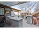 Covered outdoor kitchen with bar seating and a built-in grill at 3039 N Milwaukee St, Denver, CO 80205