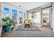 Serene sitting area bathed in natural light, showcasing French doors, comfy seating, and stylish decor at 3039 N Milwaukee St, Denver, CO 80205