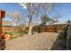 Fenced backyard with mature tree providing shade and space for outdoor activities or garden at 4922 S Rifle Ct, Aurora, CO 80015