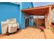 Back deck attached to a bright blue house, equipped with grill and patio seating for relaxation at 4922 S Rifle Ct, Aurora, CO 80015