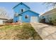 Inviting two-story blue home featuring well-maintained lawn and convenient driveway leading to the garage at 4922 S Rifle Ct, Aurora, CO 80015