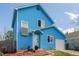 Charming two-story blue house with white trim, a manicured yard, and an attached garage at 4922 S Rifle Ct, Aurora, CO 80015