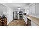 Functional kitchen featuring stainless steel appliances, white cabinetry, and tiled flooring at 4922 S Rifle Ct, Aurora, CO 80015