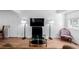 Modern living room with sleek hardwood floors, entertainment center, and stylish seating at 4922 S Rifle Ct, Aurora, CO 80015
