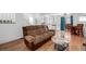 Open concept living and dining area featuring hardwood floors, a cozy sofa, and table and chairs at 4922 S Rifle Ct, Aurora, CO 80015