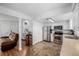 Open-concept living area with a sofa, kitchen, and staircase at 4922 S Rifle Ct, Aurora, CO 80015