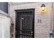 Close-up of Unit 11's secured doorway with decorative security screen and a vintage outdoor light at 1310 N Corona St # A, Denver, CO 80218