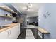 Cozy kitchen featuring modern appliances and floating shelves, seamlessly flowing into the living area at 1310 N Corona St # A, Denver, CO 80218